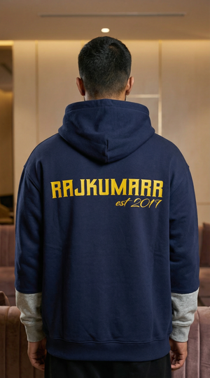 Model wearing a navy blue Rajkumarr hoodie, rear view